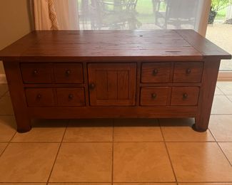 Coffee table with drawers and center door.