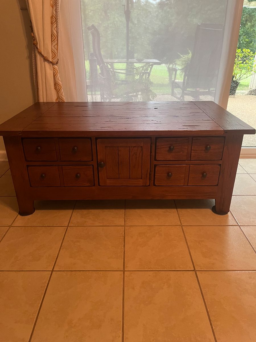 Coffee table with drawers and center door.