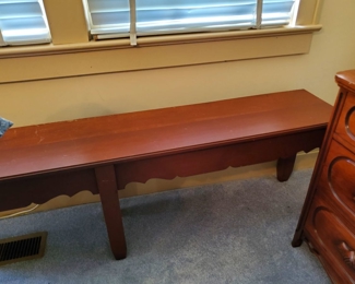 Long bench to put at the foot of a bed or foyer to a house.
