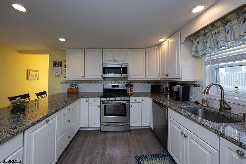 Nicely updated kitchen with pretty white cabinets - first floor unit