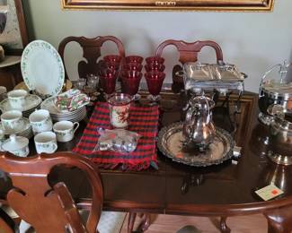 Beautiful China, Glassware, and Silver Items adorn this lovely Dining Room Table