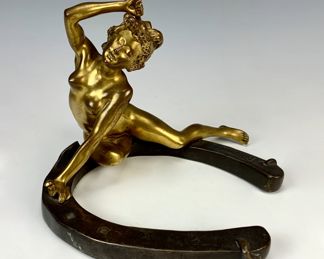 NUDE BRONZE ON HORSESHOE