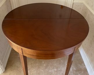 Caledonian Reproduction Mahogany Demi-Lune Flip-Top Game Table. Inlayed with Eagles. Measures 18"- 36" D x 29"H. Photo 2 of 4.