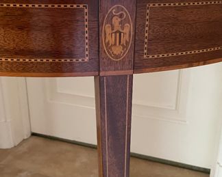 Caledonian Reproduction Mahogany Demi-Lune Flip-Top Game Table. Inlayed with Eagles. Measures 18"- 36" D x 29"H. Photo 4 of 4.