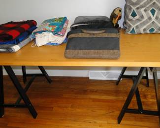 Sawhorse desk table, nice blankets, and what nots on top
