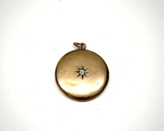 Large selection of jewelry, including gold pendant with center stone