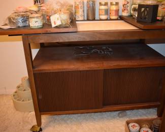 MCM Dining Room Suite by Lane Company, Alta Vista, consists of Beautiful Dining Room Table with leaf ( 80" in length), 6 Side Chairs, 2 Captain's Chairs - Gorgeous China Cupboard consisting of lighted China Cupboard and Buffet with 3 Center Drawers and Linen Fold Cupboard Doors on each side ( Immaculate!) The height is 6' 1 1/2") *plus* Warming Cart with Slide Open Top revealing porcelain food warming plate to keep those hot dishes hot and ready to serve.  The cart is 39 3/4" in length, 21" in depth, 30 1/2" high, Linen Fold Sliding Doors on Bottom and Wheels with "Brass Protectors". This Gorgeous Rare Lane Set will be offered as one complete unit to start with offers taken on individual pieces.