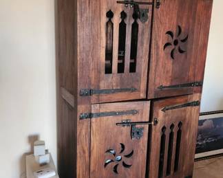 Rustic wood cabinet with metal hinges and pulls