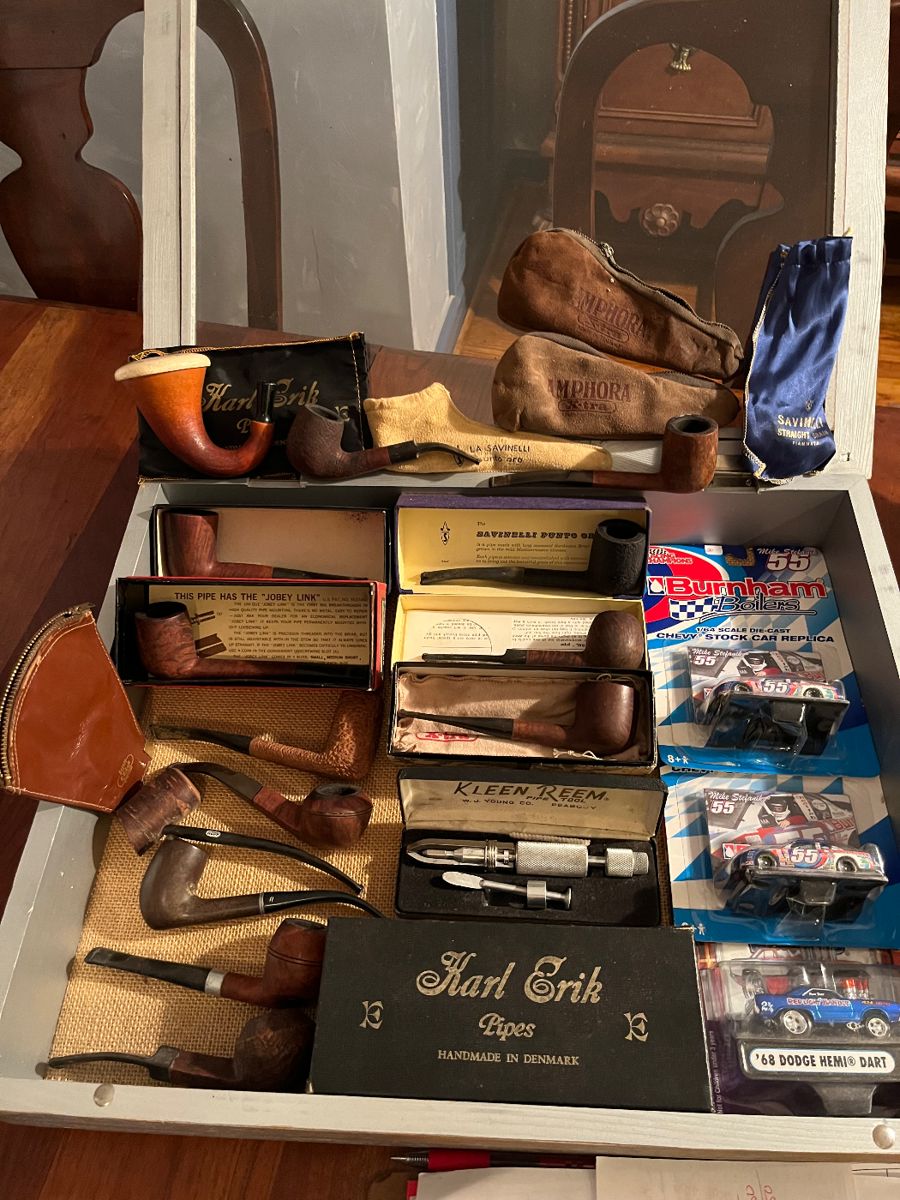 Excellent selection of tobacco pipes including Savinelli straight grain made in Italy, Savinelli made in Punto Oro, Amphora extra, Arlington and Karl Erik handmade in Denmark.  Also included in this showcase are Burnham boilers race cars scale 1/64 still in packages.