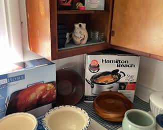 Crockpot, roasting pan, spiral slicer, handpainted ceramic bowls and wooden salad bowls.