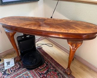 beautiful banded wood oval console and a Shark robot vacuum