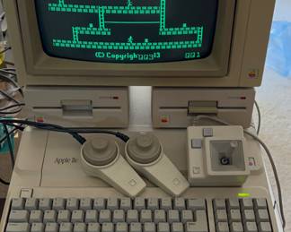 Original Apple IIe personal computer with dual disk drives and monitor