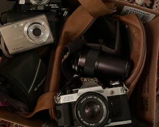 Vintage cameras, binoculars, and Canon AE-1 35 mm camera