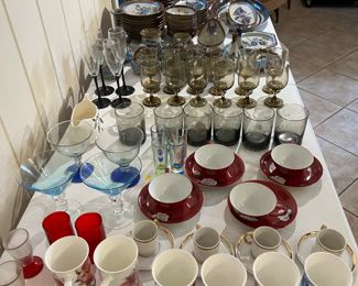 Tons of glassware. Many with matches or full sets. Farthest side of table features Ken Edwards Tonala Palomar dish set (40+ pieces)