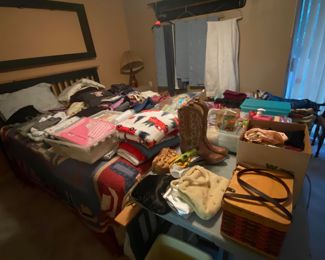 Master bed. Lots of clothes drapes and curtains