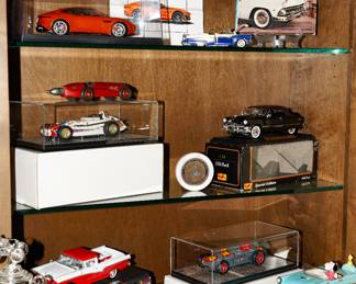 There are many car models of various shapes and sizes available for sale.  There are 3 Carousel Roadsters, an AutoArt Jaguar F-Type R Model, a Peanuts musical figurine car, a 1930's Hubley die cast race car, a collection of Pen-Joy and Winn Ross semi trucks, die cast models by Revel, Maisto, and others. 