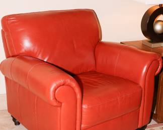 There are two red leather club chairs available for sale-in great condition. 