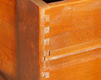 Note the dove tail joints on this hand made walnut and flame mahogany chest?