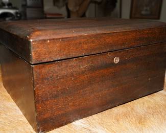 Vintage wood box holding bakelite poker set 