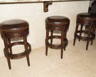 There are 4 leather topped wood swivel bar chairs available. 