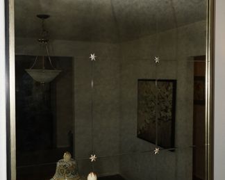 Pottery Barn mercury glass wall mirror with small flowers as decor