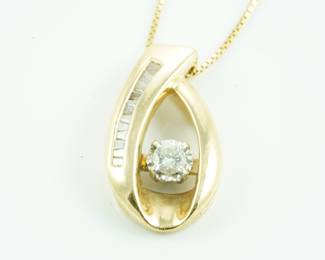 Diamond solitaire with baguettes in 14k pendant and 14k chain. The center diamond is about .4-.5ct.