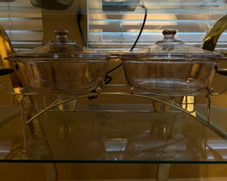 Double-casserole warmer, Fire-King from the 1940s, clear glass speckled with gold, with gold trim on lids and candle warmer under each casserole.