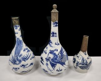 THREE CHINESE BLUE AND WHITE WARE BOTTLES FOR THE VIETNAMESE MARKET. 19TH CENTURY. SMALLEST IS 5.75" TALL AND HAS A BRONZE COVERED NECK. TALLEST WITH STOPPER HAS REPAIRED CRACKS ON THE BODY