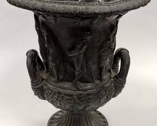 CARVED GRAPHITE URN WITH GREEK THEME. 10.75" TALL. REPAIR ON FOOT