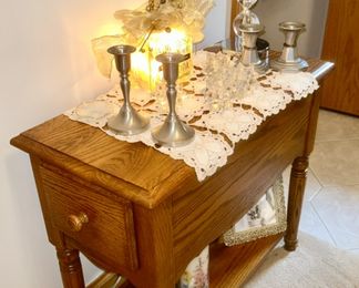 Close up view of oak side table with end drawer