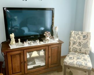 Flatscreen TV, decorative angels, etc., entertainment stand, side chair, metal wall art