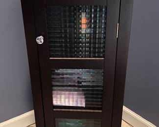 Black bathroom storage with glass doors