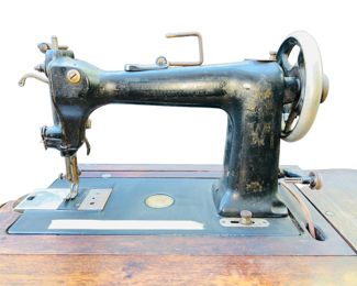 Antique 19th Century Wheeler Wilson (Singer) Sewing Machine D-9 With Original Table | Machine is marked Wheeler & Wilson MFG Co., Bridgeport Conn. D9. Patented Jul. 17th 88. Mar 25th 90. Aug. 2nd 92. No. 2981281 | Also with gold medallion embossed with "Wheeler & Wilson M'fg Co., Bridgeport, Conn. U.S.A." Approx. Measurements: 29.25" High with Sewing Machine Folded In; Opened: 47" L (When Opened); Closed: 32 1/8" L; 16" W.
