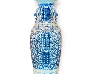 Large Chinese Canton Blue on White Porcelain Vase. Qing Dynasty, 19th century. Floor or grand table top vase hand-painted over entire vase, displaying the double happiness / double luck symbols, The body and neck is decorated in an overall design of peonies within vining foliage and the shoulders of the vase is reverse decorated with bats. Also decorated with double Chinese guardian lions (foo dogs). The concept, which originated and became p handles. Approx. size: 24" Tall.