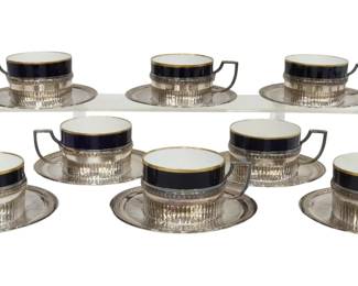 Lot of 16 LAGRIFFOUL & LAVAL .950 Sterling Silver Cups & Saucers | Neoclassical design with foliate and ribbed borders, Minerva hallmark in canted cartouche, including: (8) handled cup holders, cobalt-glazed porcelain insert with gilt rim, approx. cup size: 2 1/8" H x 4.25" W x 3.25" D (measurements inclusive of handle) and (8) saucers, approx. 5 5/8" D; 44.49 ozt total (weighable silver only).