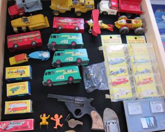 Tin 1940s Marx and Linemar trucks. Vintage 60s-70s Matchbox cars. Tom Mix wood straight shooter, Hohner harmonica in the box, military whistle and vintage lighters.