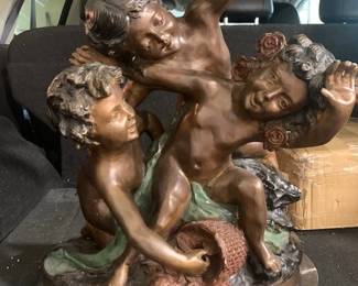 20th Century Cast Bronze Sculpture accent piece after Joseph D'Aste (1881-1945).  Depicts 3 cherub figures playing with a basket of flowers.