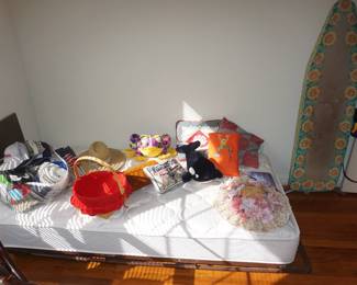 twin mattress, baskets, ironing board
