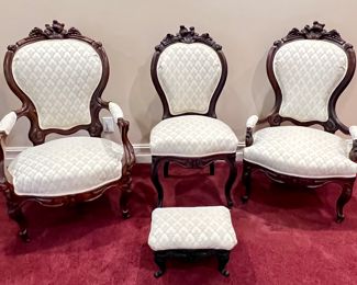 Antique Victorian Four Piece Walnut Parlor Set. This lovely set includes a gentlemen's chair, ladies chair, foot rest and an additional side chair. The footrest features a metal base and measures 15" x 11" x 8". The gentlemen's chair measures about 27" x 22" x 44" 