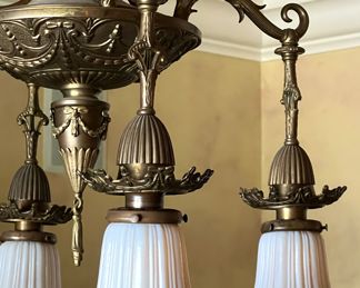 Gorgeous Dining Room Chandelier Four with Quezal Glass Shades. 

A beautiful ornate brass intricately designed fixture paired with four beautiful Quezal white and Aurene glass shades. 

Measures about 35" long and 19" wide with each shade measuring about 4.5" long. 