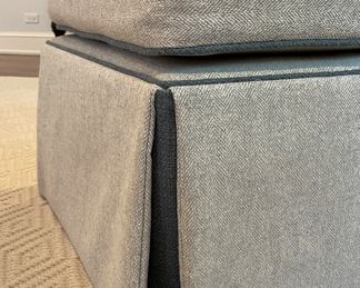 Kravet Ottoman Upholstered in Light Grey Herringbone Fabric with Contrasting Dark Grey Faux Leather Trim. Measures 22" x 28" x 21" H. Photo 2 of 3.