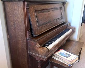 Vintage piano with bench and song books 