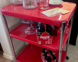 Adorable red rolling rack and vintage Coca Cola bottles