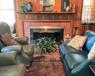 Matching green leather wingback chairs; darker green leather loveseat