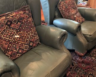 Matching green leather wingback chairs