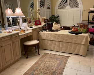Master bedroom bath suite boutique featuring designer handbags , clothing, shoes and coats