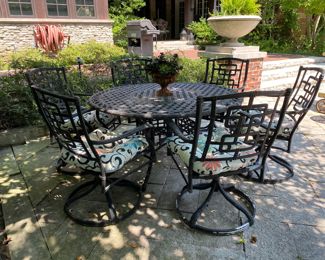 $1500.00 Cast aluminum dining table (with Lazy Susan center) & 6 swivel chairs  table: 27"h x 54" diameter        some flaking in areas