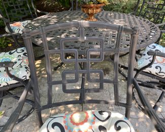 $1500.00 Cast aluminum dining table (with Lazy Susan center) & 6 swivel chairs  table: 27"h x 54" diameter        some flaking in areas