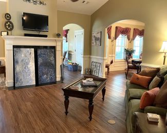 large canvas art, decor, side tables, end tables, coffee tables, throw pillows, green fabric soda, couch, lamps, wall art