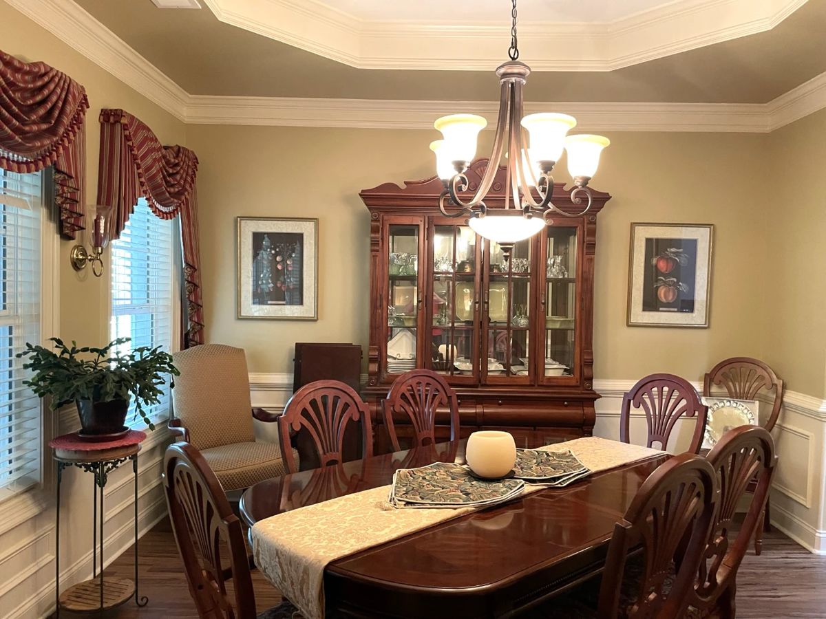 Full hardwood dining set with china cabinet, rug, decor, framed wall art